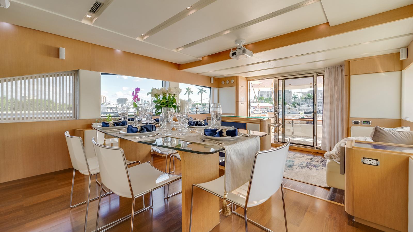 Indoor dining area with projector screen Aicon 75 Miami yacht