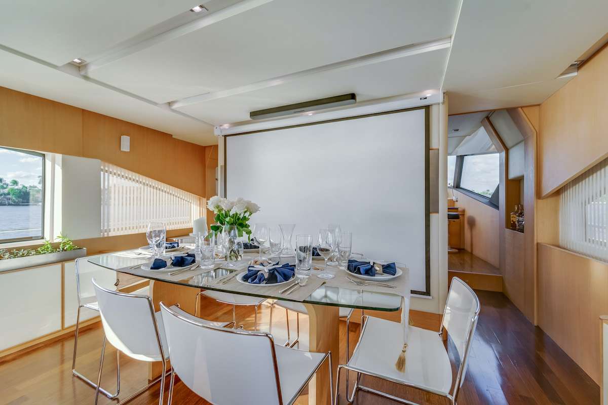 Indoor dining area with projector screen Aicon 75 Miami yacht