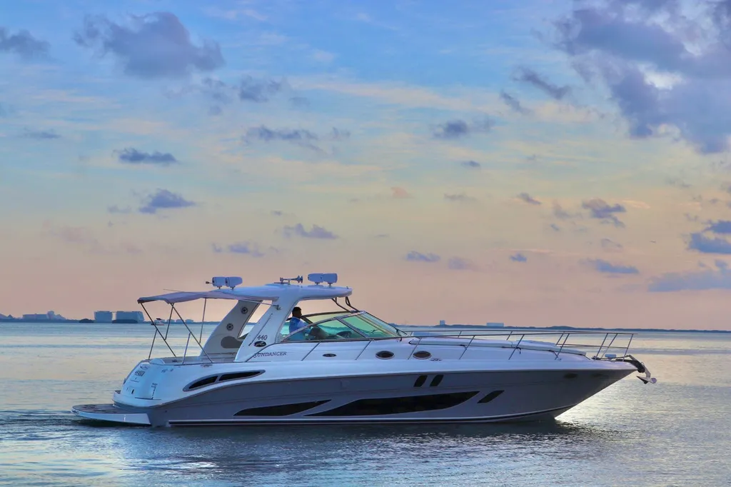 Sea Ray 440 Sundancer at golden hour off the Cancún Hotel Zone, Marina Mundo Marino