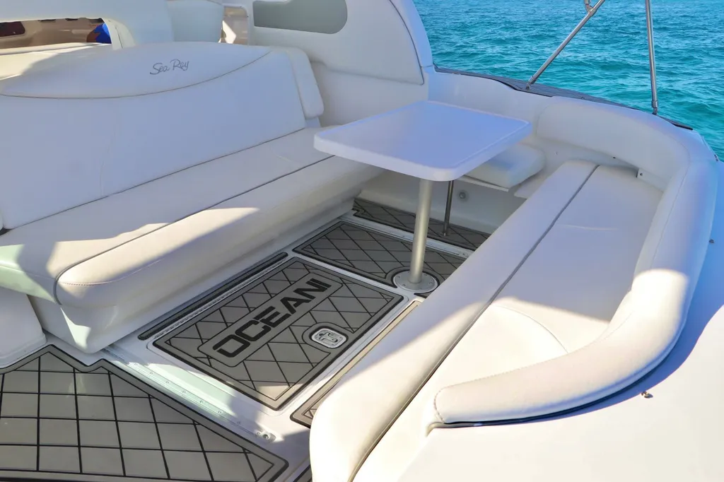 The stern cockpit of a private Sea Ray charter over turquoise water